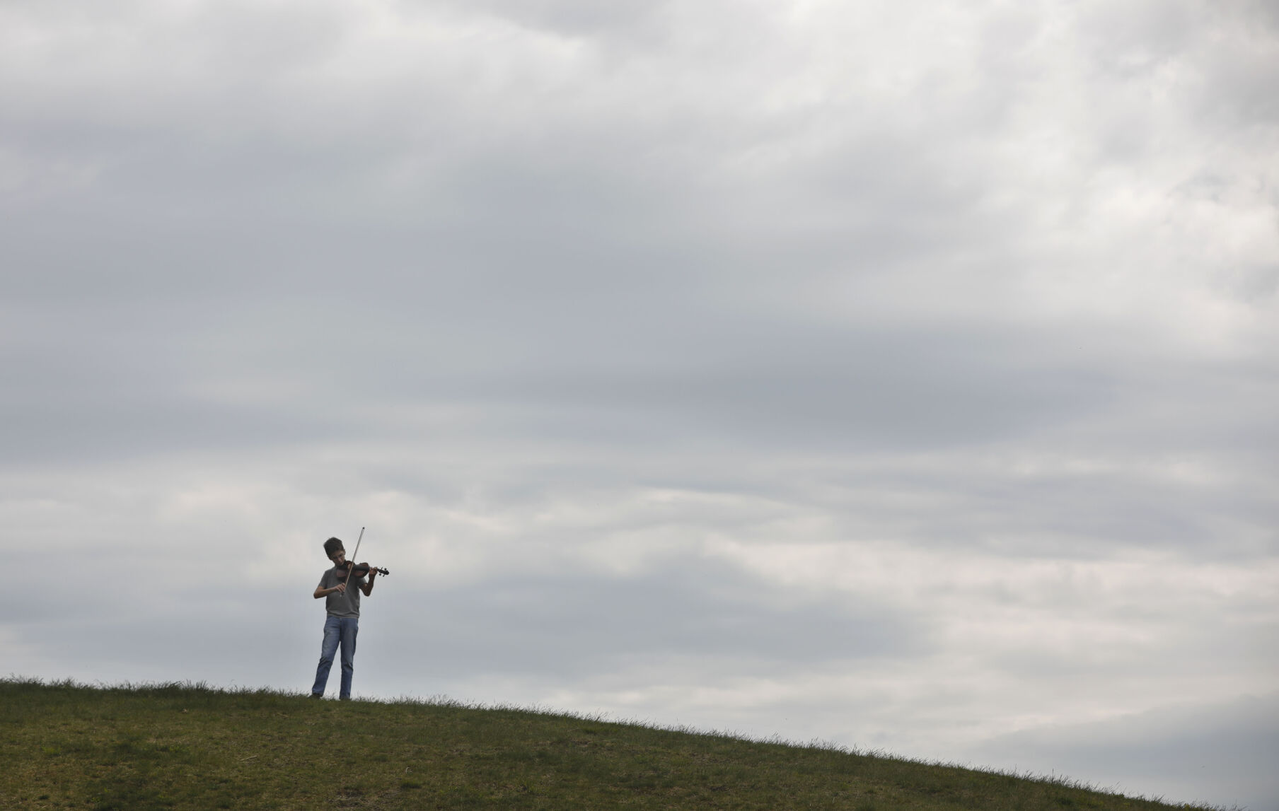 evan miller playing violin on hilltop
